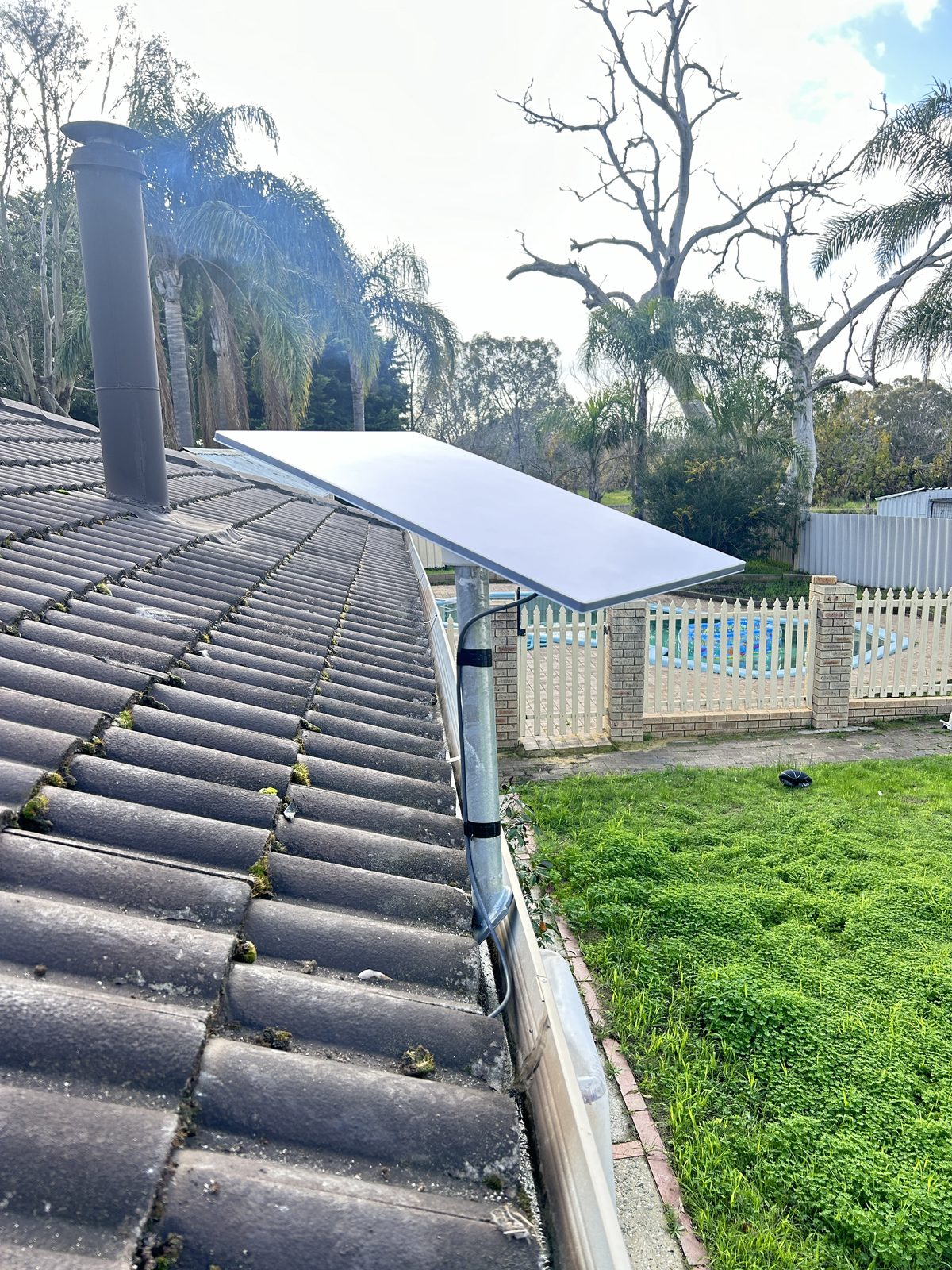 Starlink dish mounted on tile roof, rural property